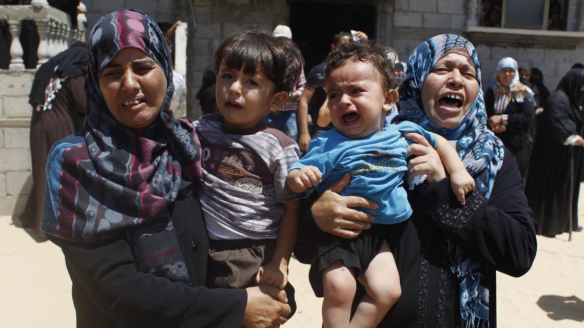 elatives mourn during the funeral of four members of the Moamer family, including a 26-year-old militant of the Hamas movement, after they were killed in an Israeli air strike in southern Gaza Strip city of Rafah, on July 14, 2014.