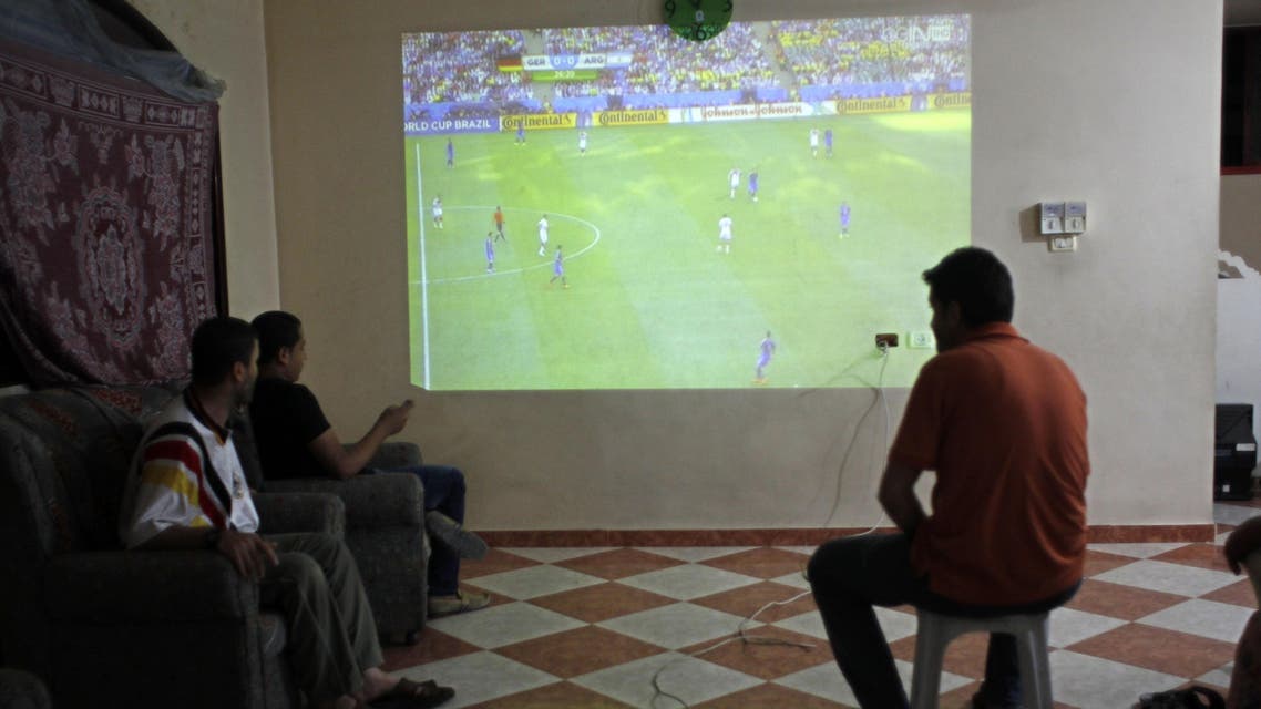 Palestinians watch a television projection of a live telecast displaying the the 2014 FIFA World Cup final between Argentina and Germany in Brazil, in the southern Gaza Strip town of Rafah on July 13, 2014. AFP