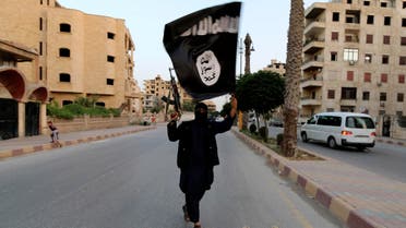 A member loyal to the Islamic State in Iraq and Syria (ISIS) waves an ISIS flag in Raqqa June 29, 2014. (Reuters)
