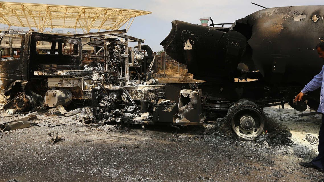 The wreckage of a truck and an airplane are seen at Tripoli international airport in the Libyan capital on July 14, 2014 afp