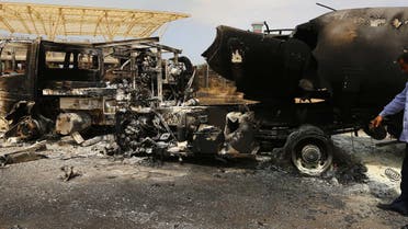 The wreckage of a truck and an airplane are seen at Tripoli international airport in the Libyan capital on July 14, 2014  afp 