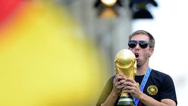  Germany's captain Philipp Lahm celebrates with the trophy during a victory parade of Germany's football national team on July 15, 2014 