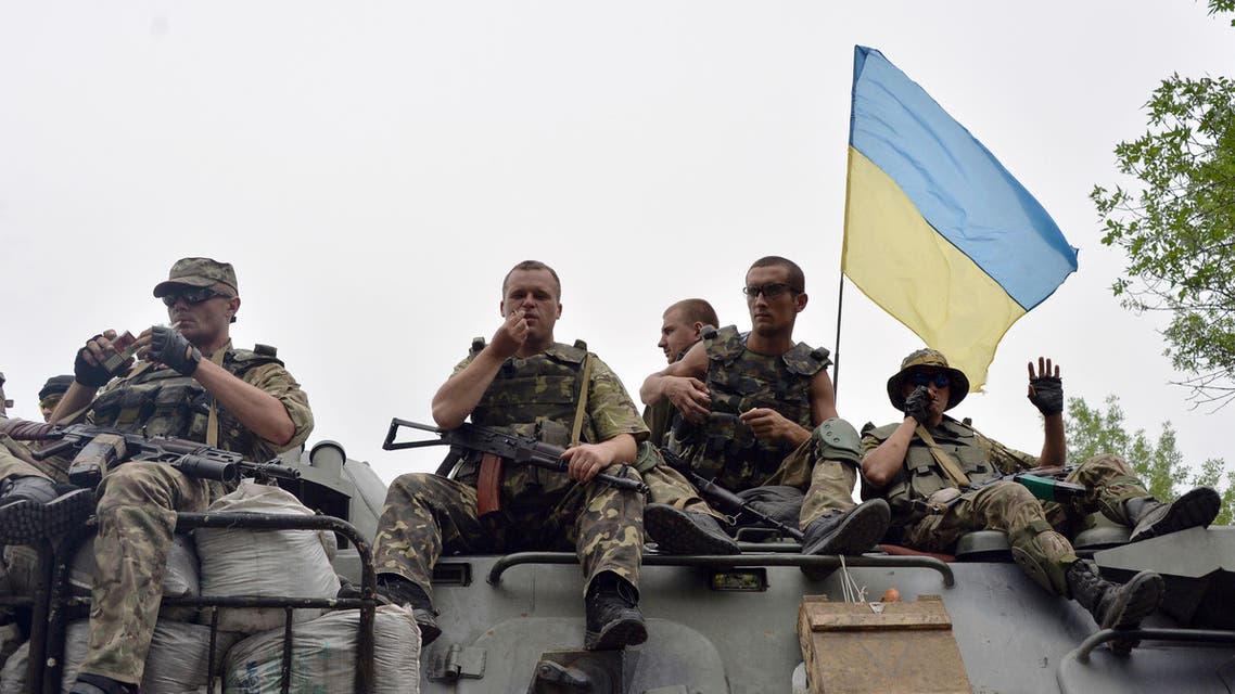 Ukrainian soldiers sit atop an armored personnel carrier (APC) as they travel near the eastern Ukrainian city of Slavyansk on July 18, 2014. (AFP)