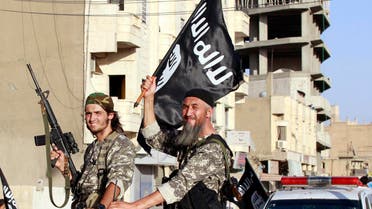 Militant Islamist fighters wave flags as they take part in a military parade along the streets of Syria's northern Raqqa province June 30, 2014. reuters