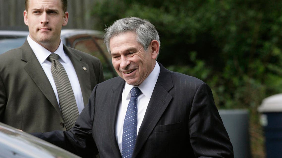 Paul Wolfowitz (R) leaves his house in the Washington suburb of Chevy Chase, Maryland, May 17, 2007.