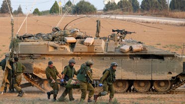 Israeli soldiers carry a comrade on a stretcher, who was wounded during an offensive in Gaza, outside northern Gaza July 20, 2014.