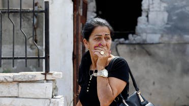 A woman reacts as she passes by a house damaged by a rocket, fired by Palestinian militants, that landed in the southern town of Sderot July 21, 2014. Reuters