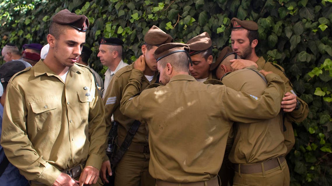 Israeli soldiers mourn during the funeral of their comrade Moshe Malko at the Mount Herzl military cemetery in Jerusalem July 21, 2014. 