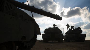Israeli soldiers stand atop tanks outside central Gaza Strip July 19, 2014. (Reuters)