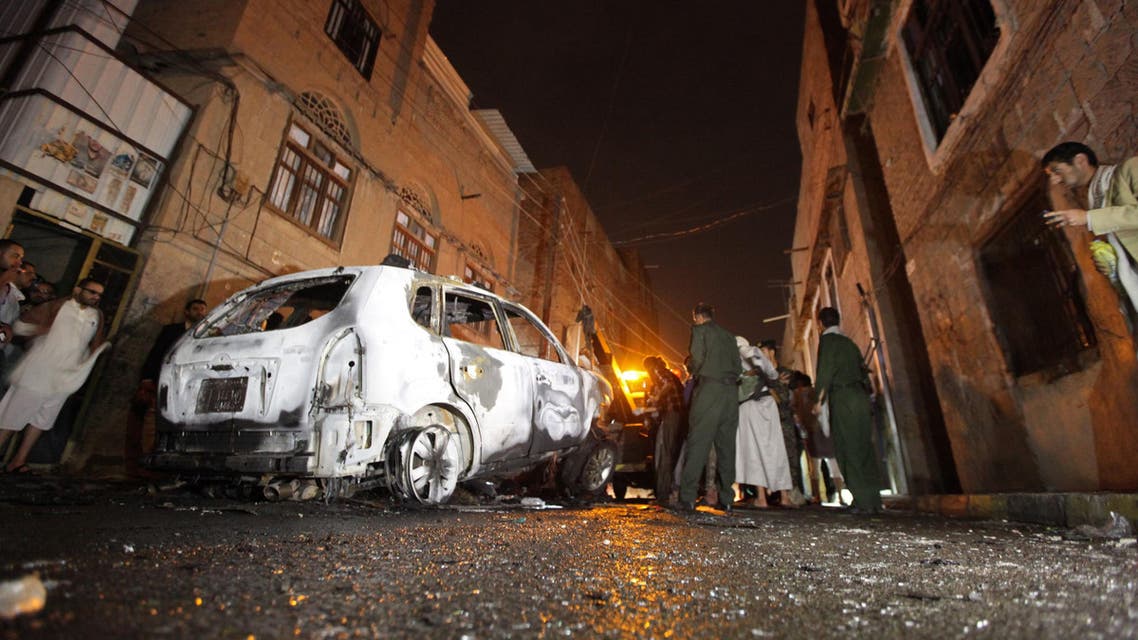 Policemen inspect the scene of a blast that destroyed the car of Abdullah al-Mutawakil, a senior security officer, outside his house in Sanaa early July 20, 2014. Reuters