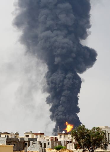  A picture taken on July 28, 2014 shows flames and smoke billowing from an oil depot where a huge blaze started following clashes around Tripoli airport, in southern Tripoli.  (AFP)