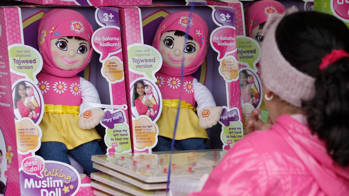A young girl admires talking Muslim dolls for sale on a stall at the Trafalgar Square's "Eid in the Square" festival in London
