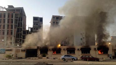 Smoke from a fire at a police station is seen in Benghazi July 6, 2014. 