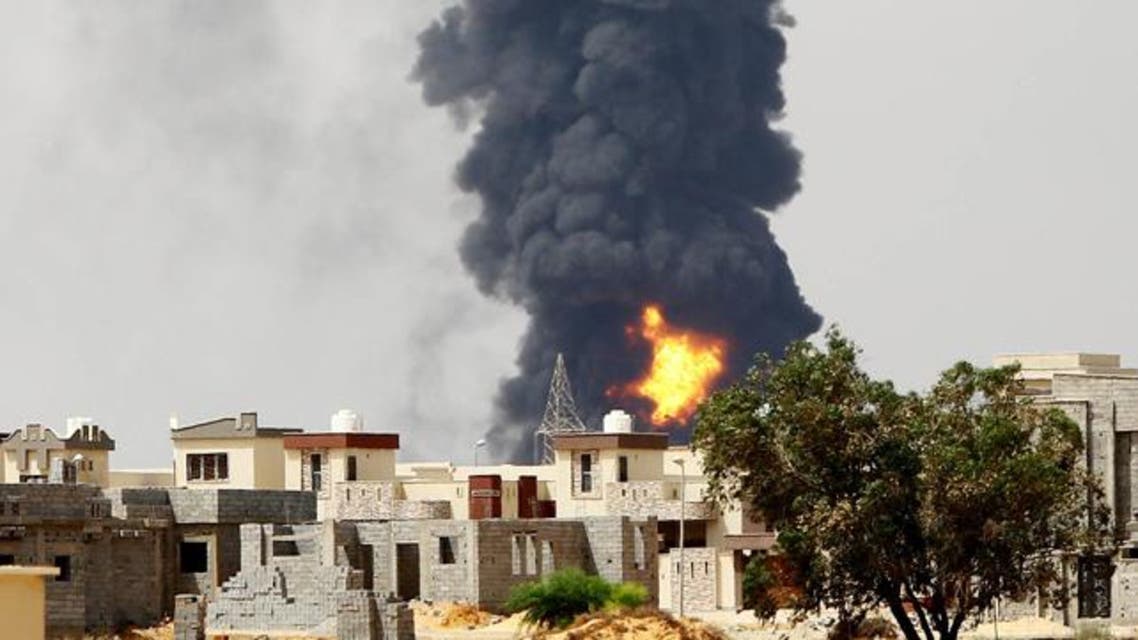 A picture taken on July 28, 2014 shows flames and smoke billowing from an oil depot where a huge blaze started following clashes around Tripoli airport, in southern Tripoli. (AFP)