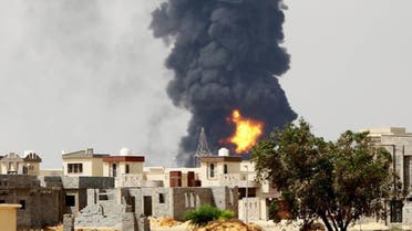 A picture taken on July 28, 2014 shows flames and smoke billowing from an oil depot where a huge blaze started following clashes around Tripoli airport, in southern Tripoli. (AFP) 