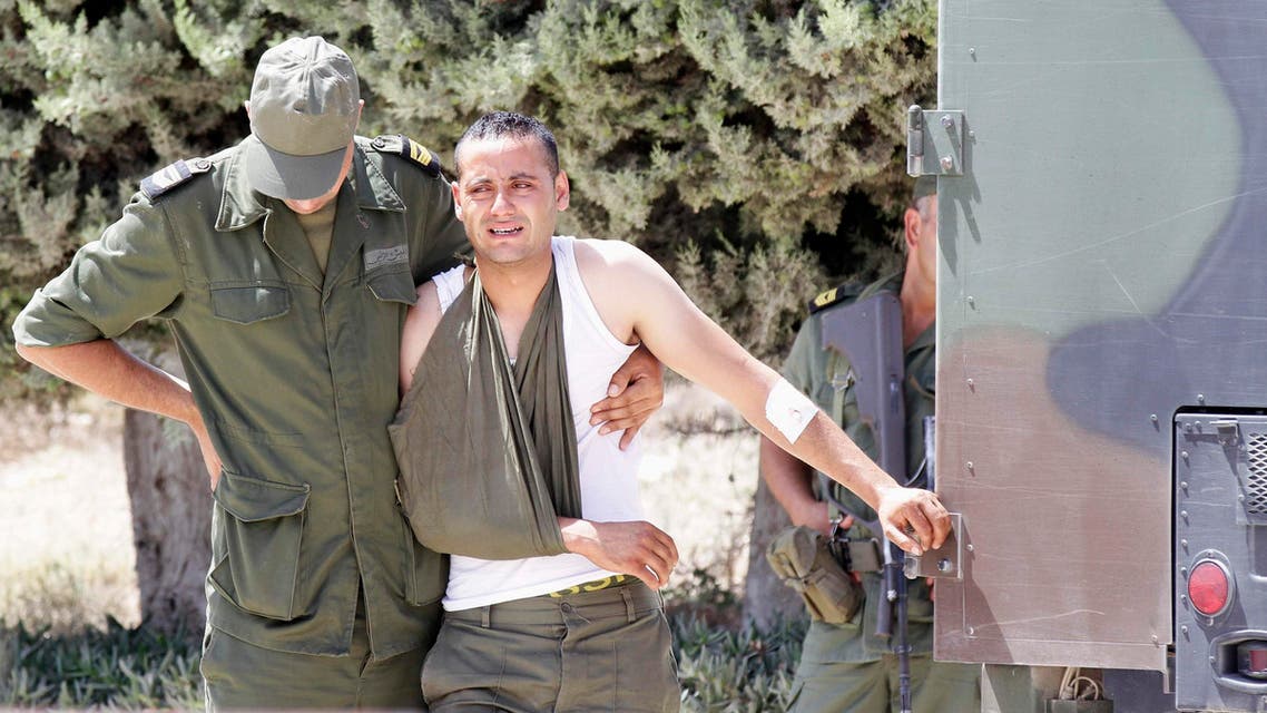 A wounded soldier mourns the death of his colleague Lamjid al-Arfaoui during his funeral as they proceed to Kef Cemetery in Kef, 168 km (104 miles) from Tunis, July 27, 2014.
