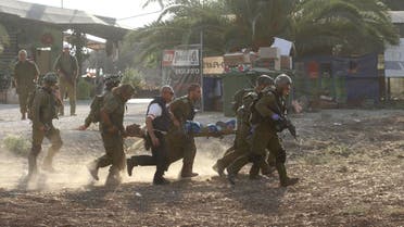 Israeli soldiers carry their comrade on a stretcher after he was wounded in a Palestinian mortar strike, as they evacuate him from the scene outside the central Gaza Strip July 28, 2014. (Reuters)