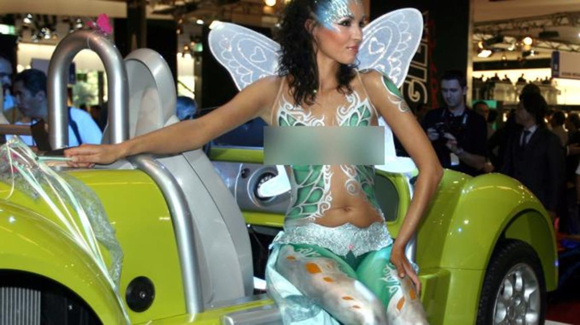 A topless body-painted model presents the French-made Acrea Zest on media day at the Paris Mondial de l'Automobile September 28, 2006.