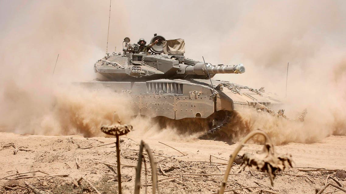 An Israeli soldier gestures from a tank near the border after returning to Israel from Gaza August 3, 2014. (Reuters)
