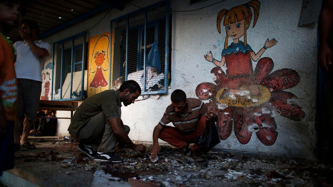 Palestinians collect the remains of bodies at a United Nation-run school sheltering Palestinians displaced by an Israeli ground offensive, that witnesses said was hit by Israeli shelling, in Jebalya refugee camp in the northern Gaza Strip July 30, 2014.