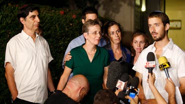 Zur Goldin (R), brother of Israeli soldier Hadar Goldin, and other family members talk to the media outside their home in the central Israeli city of Kfar Saba August 2, 2014
