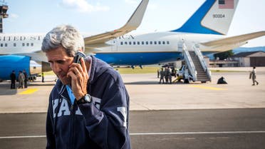 U.S. Secretary of State John Kerry speaks on his phone while his plane refuels at Ramstein Air Base in Ramstein-Miesenbach August 1, 2014.
