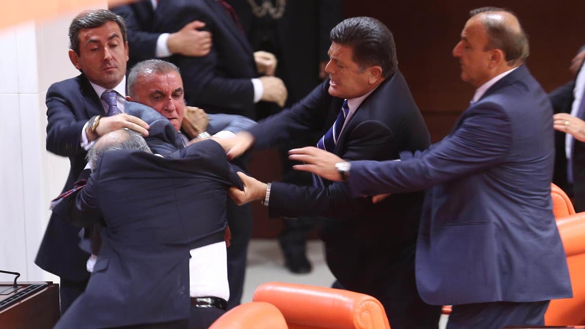 Opposition party MHP's Ali Uzunirmak (3rd L) fights with AKP's Mustafa Sahin (2nd L) at the parliament in Ankara, on August 4, 2014. (AFP)