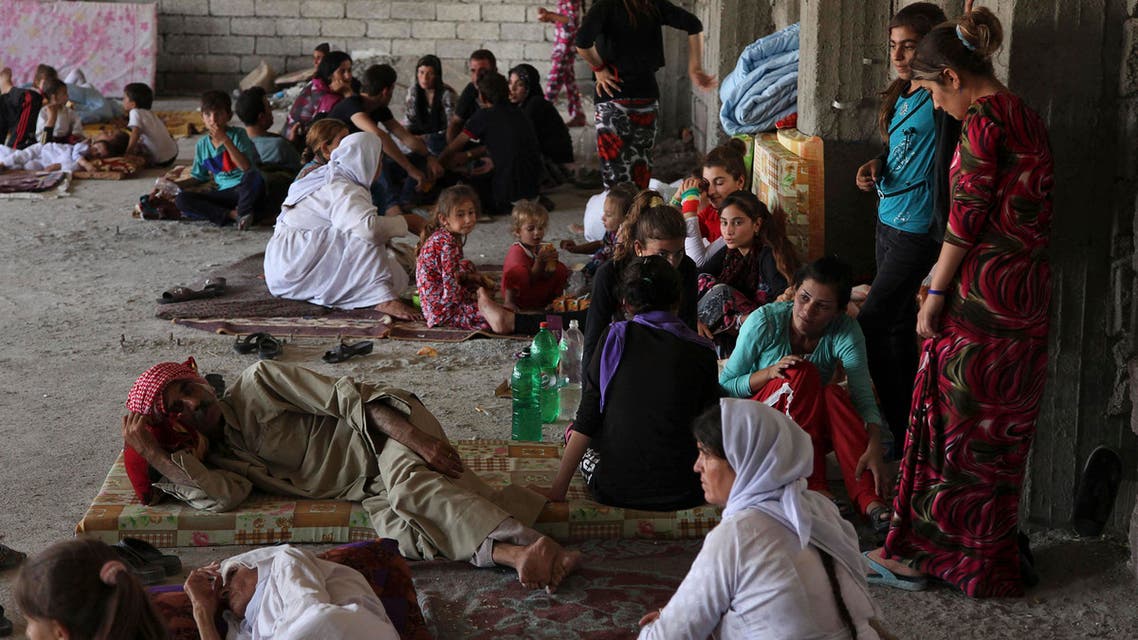 Displaced families from the minority Yazidi sect, fleeing the violence in the Iraqi town of Sinjarl west of Mosul, take refuge at Dohuk province, August 4, 2014. (Reuters)