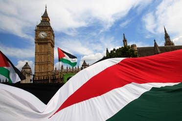 Demonstrators carry Palestinian flags as they protest outside the Houses of Parliament in central London July 26, 2014. (Reuters) 