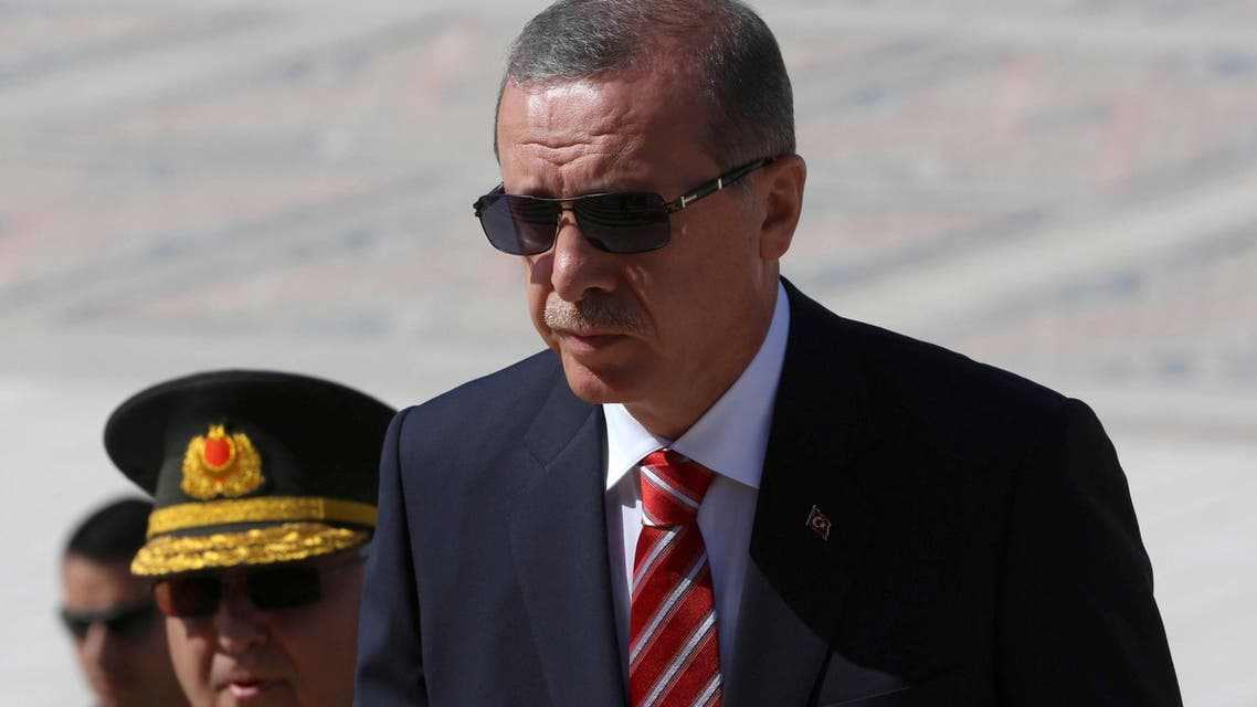 Turkish Prime Minister Recep Tayyip Erdogan (C) follows a guard of honour at the mausoleum of Turkey's founder Mustafa Kemal Ataturk prior to a meeting of the High Military Council in Ankara, on August 4, 2014. AFP