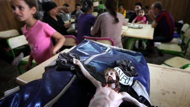  A statue of Jesus Christ is seen on the bag of an Iraqi Christian who fled the violence in the village of Qaraqush. AFP 