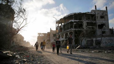 Palestinians walk amid the ruins of destroyed homes in the Shejaia neighbourhood, which witnesses said was heavily hit by Israeli shelling and air strikes during an Israeli offensive, in Gaza City August 6, 2014.