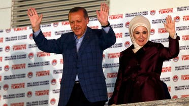 Turkey's Prime Minister Tayyip Erdogan and wife Ermine wave hands to supporters as they celebrate his election victory in front of the party headquarters in Ankara August 10, 2014.  (Reuters) 