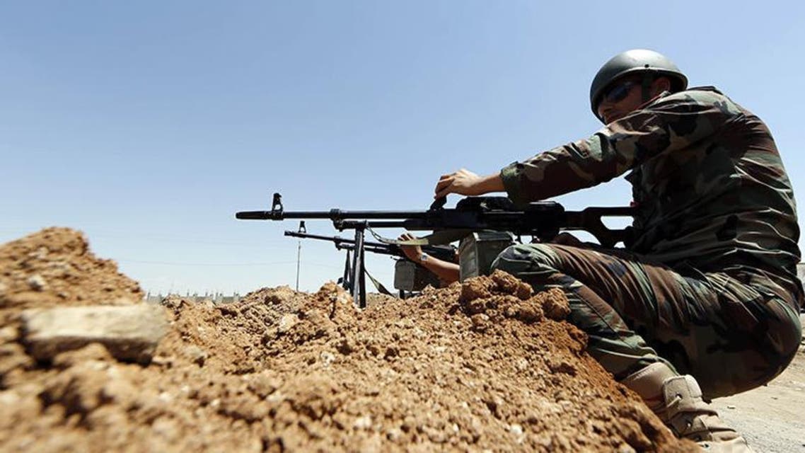 Peshmerga fighters, from Iraq's autonomous Kurdish region, take positions in the town of al-Muafakiya, 80 kms west of Erbil. (AFP)