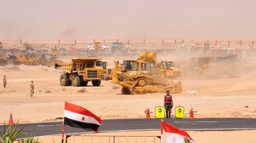 Bulldozers and trucks are seen in a demonstration of the equipment which will be used as part of plans for a major upgrade of the Suez Canal, in Cairo August 5, 2014. (Reuters) 