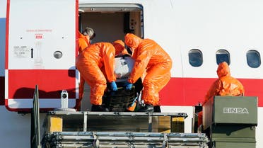 Air force personnel unload Ebola patient, Spanish priest Miguel Pajares, from an airplane at Torrejon airbase in Madrid, after he was repatriated from Liberia for treatment in Spain, August 7, 2014. (Reuters)