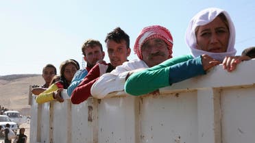 Displaced people from the minority Yazidi sect, fleeing the violence in the Iraqi town of Sinjar, re-enter Iraq from Syria at the Iraqi-Syrian border crossing in Fishkhabour, Dohuk Province, August 10, 2014. Reuters 