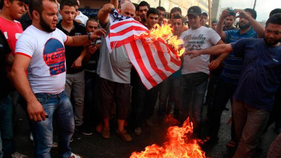 Protesters burn a U.S. flag during a protest against a film they consider blasphemous to Islam and insulting to the Prophet Mohammad in Tripoli, northern Lebanon September 13, 2012. (Reuters)