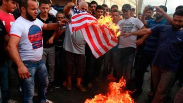 Protesters burn a U.S. flag during a protest against a film they consider blasphemous to Islam and insulting to the Prophet Mohammad in Tripoli, northern Lebanon September 13, 2012. (Reuters) 