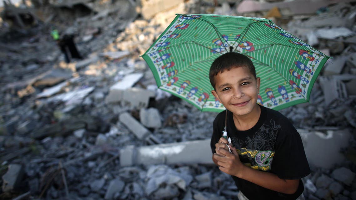 Palestinians walk in the rubble of destroyed houses in Gaza City's Shejaiya neighbourhood on August 17, 2014. AFP