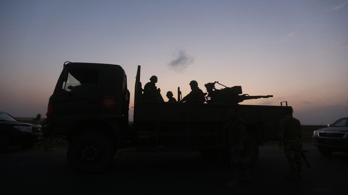 Peshmerga fighters sit on top of an armoured vehicle on the front line of fighting with ISIS militants 20 kilometres east of Mosul, on August 18, 2014. (AFP).jpg