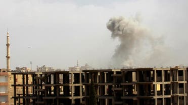 Smoke rises after what activists said was an air raid by Syrian government forces at the eastern Syrian city of Raqqa August 18, 2014. (Reuters)