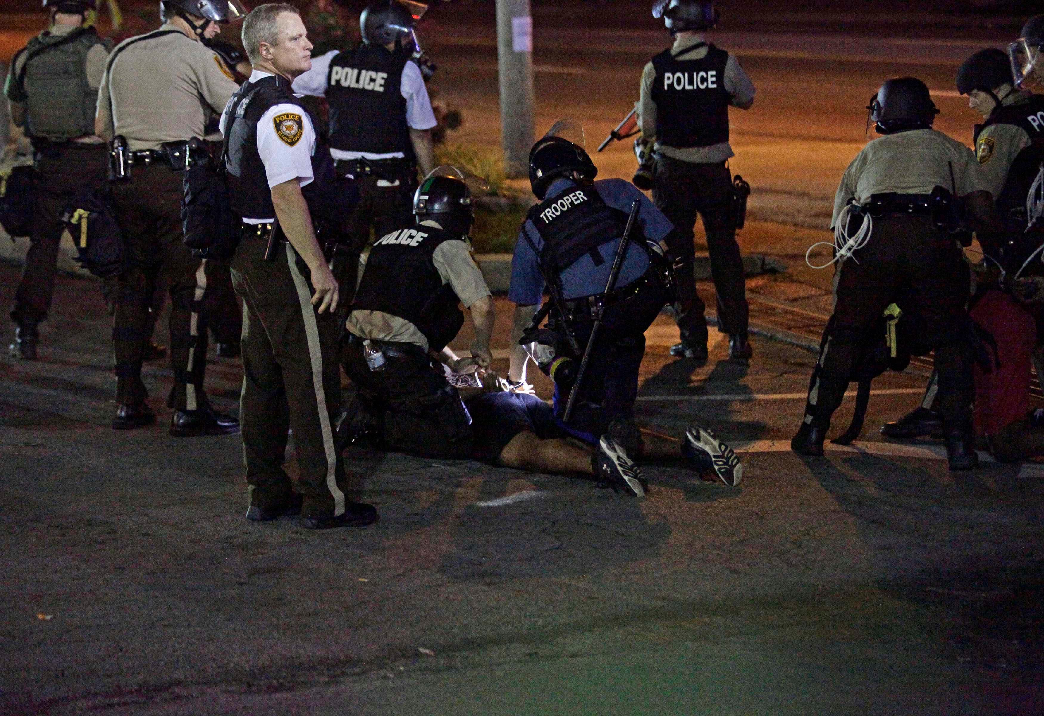 Police detain a demonstrator during a protest against the shooting death of Michael Brown in Ferguson Missouri August 18, 2014.Reuters
