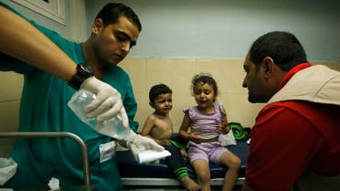 Palestinian children, who hospital officials said were wounded in an Israeli air strike, receive treatment at a hospital in Gaza City August 19, 2014. 