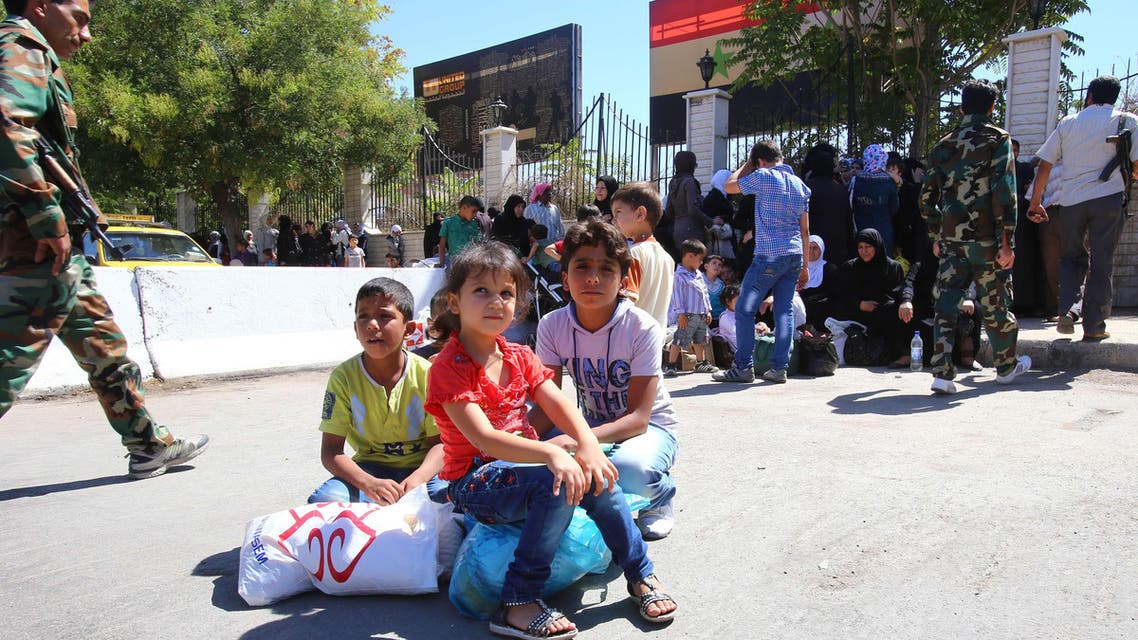 Syrian families wait their belongings in the southern Damascus district of Qadam on August 21, 2014. (AFP)