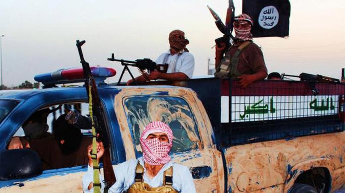 ISIS militant riding in a captured vehicle left behind by Iraqi security forces at an unknown location in Iraq. (AFP)
