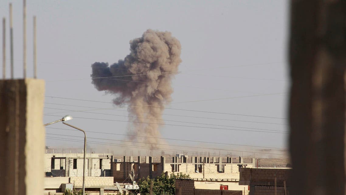 Smoke rises during what activists said was an air raid by warplanes operated by forces of Syria's President Bashar Al-Assad around al-Tabqa military base at a government-controlled airport that is surrounded by militants, west of Raqqa city, August 21, 2014. (Reuters)