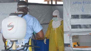: A nursing staff disinfects a doctor's outfit at the French NGO Medecins Sans Frontieres (Doctors without borders) Elwa hospital in Monrovia. (AFP)