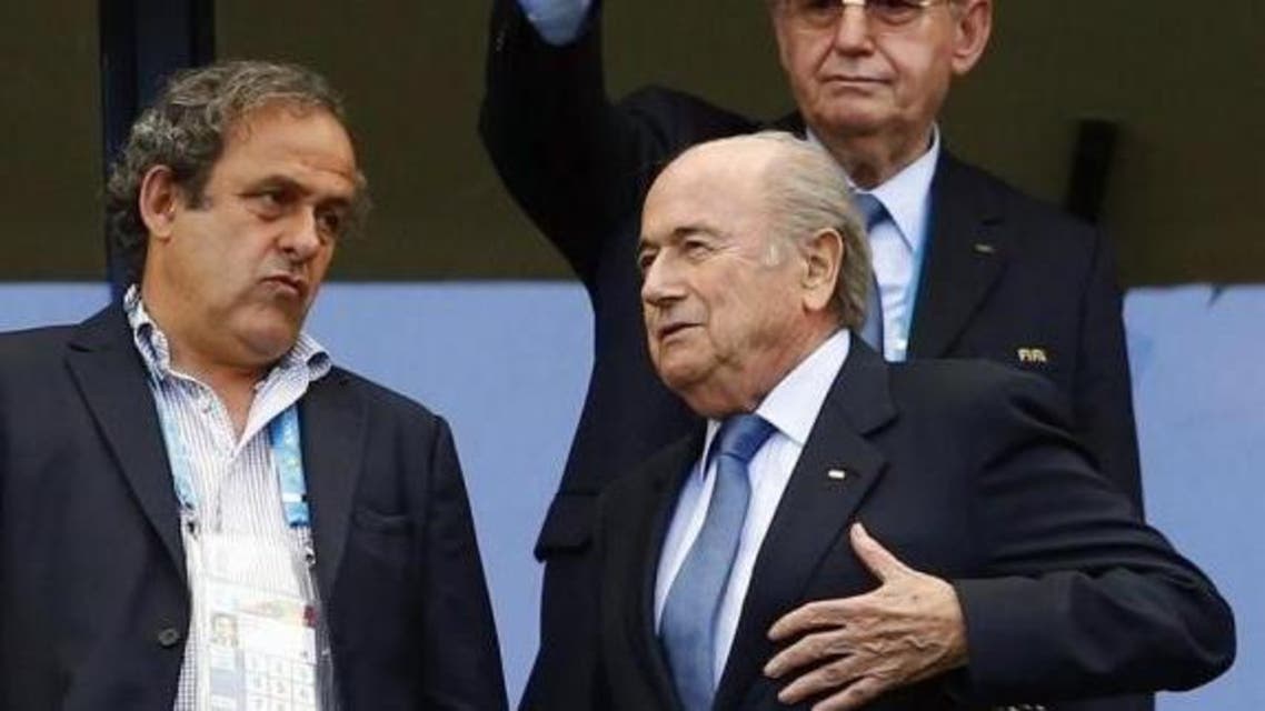 Sepp Blatter speaks with Michel Platini (L) before the 2014 World Cup Group G soccer match between Germany and Portugal at the Fonte Nova arena in Salvador June 16, 2014. (Reuters)