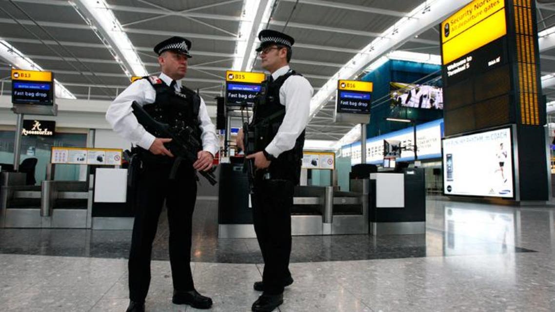 Police officers patrol the check-in hall in the new Terminal 5 building at London's Heathrow Airport (Reuters)